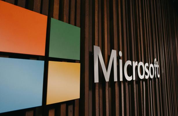 Office wall with Microsoft logo prominently displayed