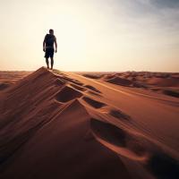 Man walking along a dune