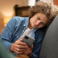 Teen boy looking at his cell phone