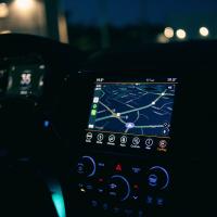 Interior view of a car featuring the GPS navigation system illuminated at night, showcasing technology and modern travel.